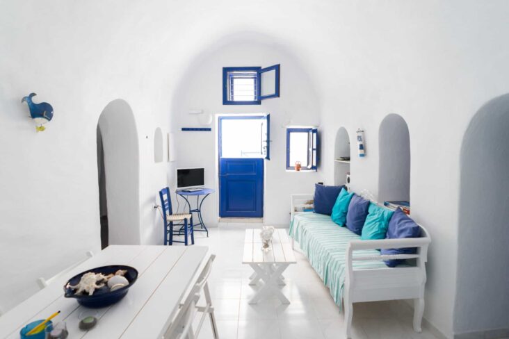 sala de estar branca com mesa de refeiçoes e sofa