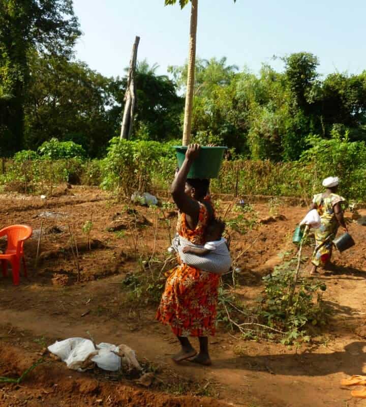 mulher africana a carregar balde na cabeça