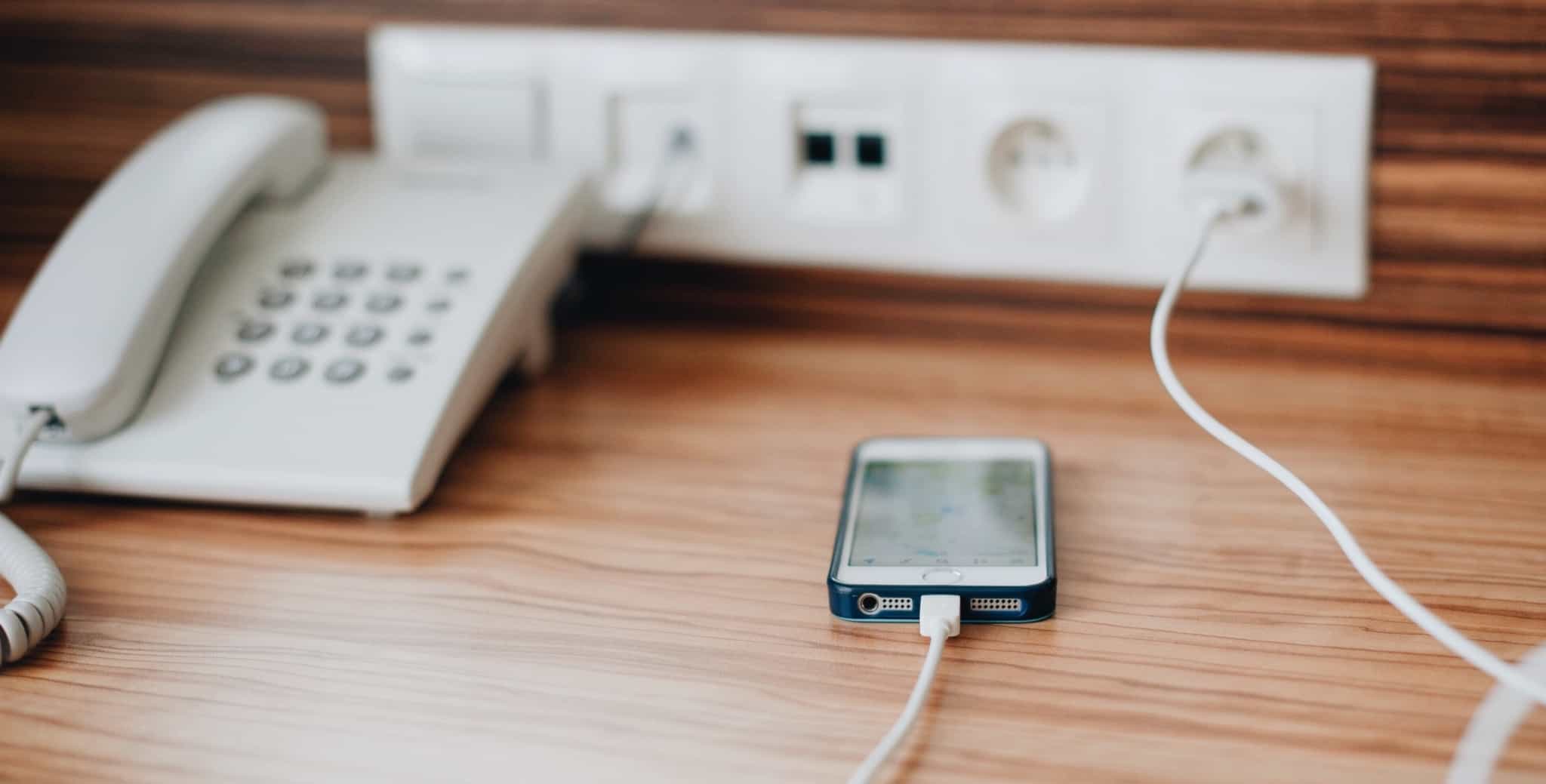 Telemóvel a carregar em quarto de hotel