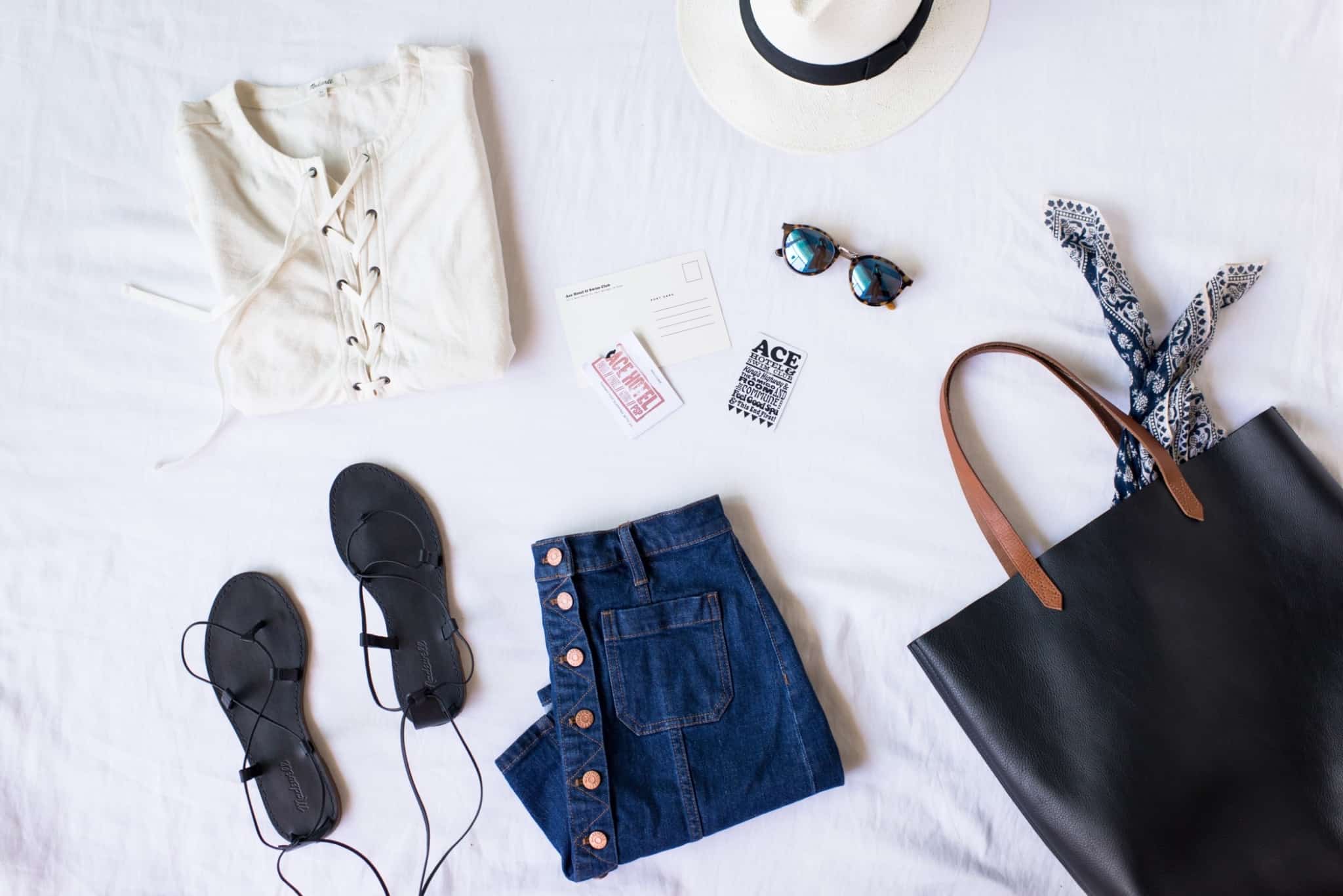 uma saia de ganga uma mala preta e umas sandálias pretas