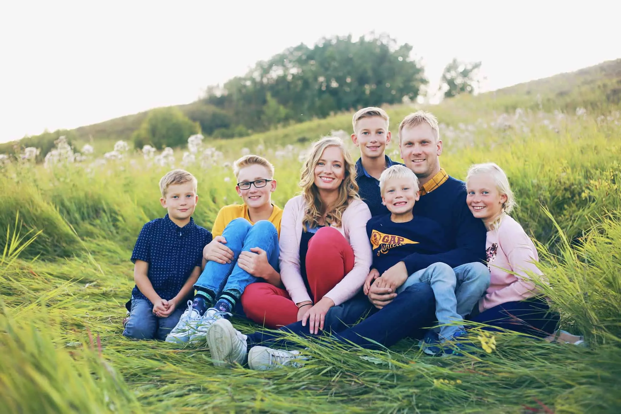 Quais as vantagens do seguro de saúde familiar? fotografia de familia com sete pessoas num campo