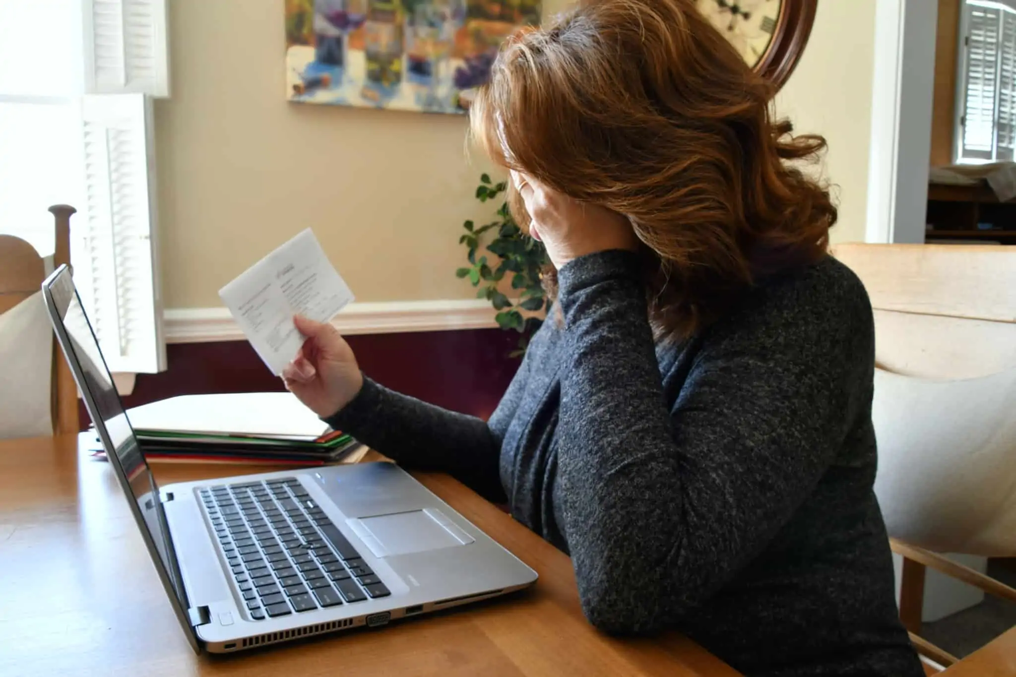 Conheça as respostas às dúvidas mais frequentes sobre o RSI mulher preocupada a ver um carta
