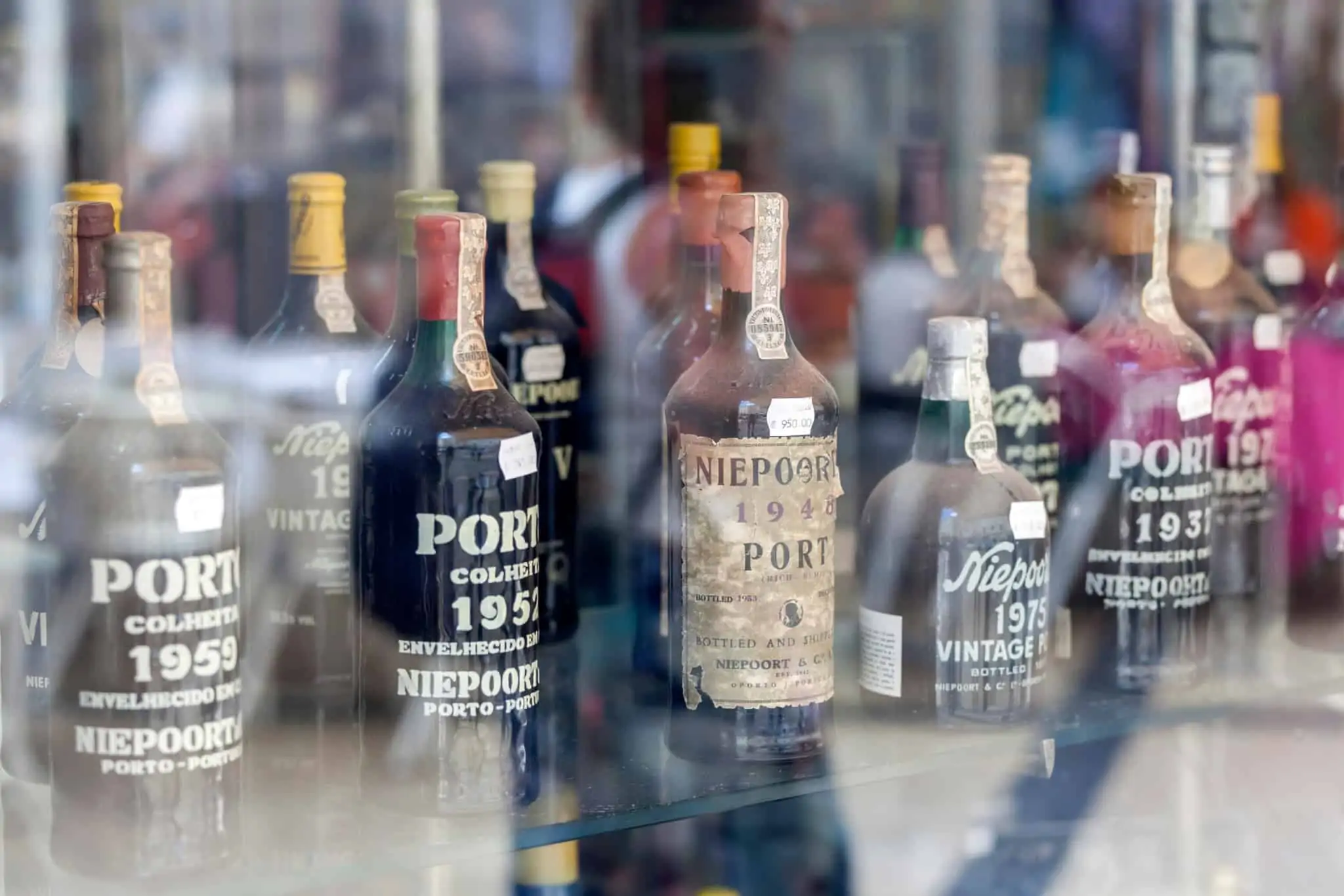 investimento em artigos colecionáveis, como o conjunto de garrafas antigas de Vinho do Porto que vemos nesta imagem, pode trazer um bom retorno