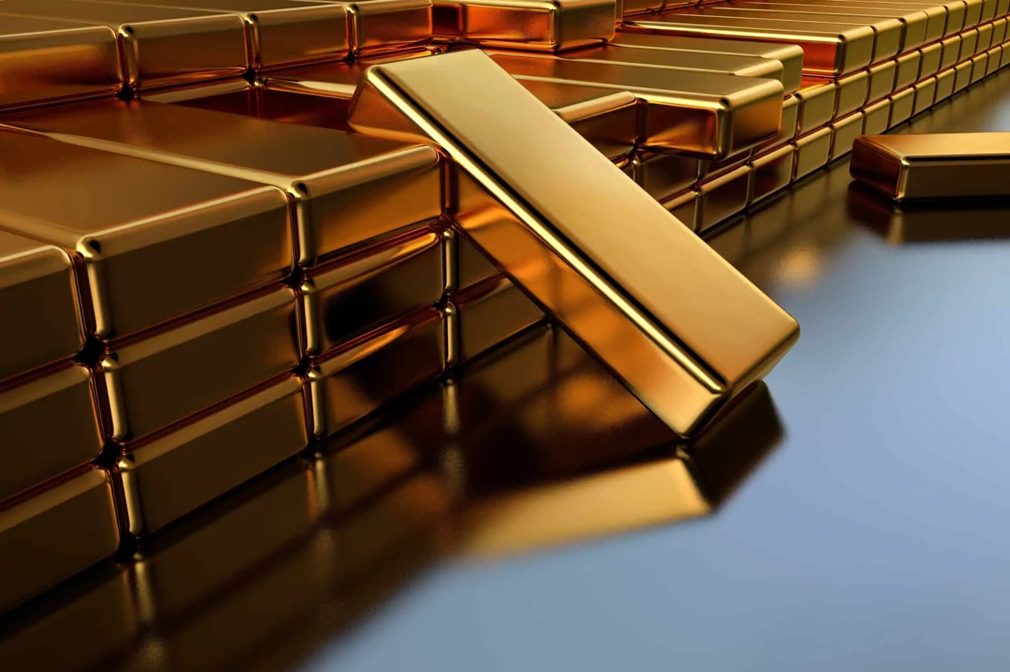 Comprar barras de ouro: Onde, como e quanto custam? barras de ouro arrumadas em várias pilhas