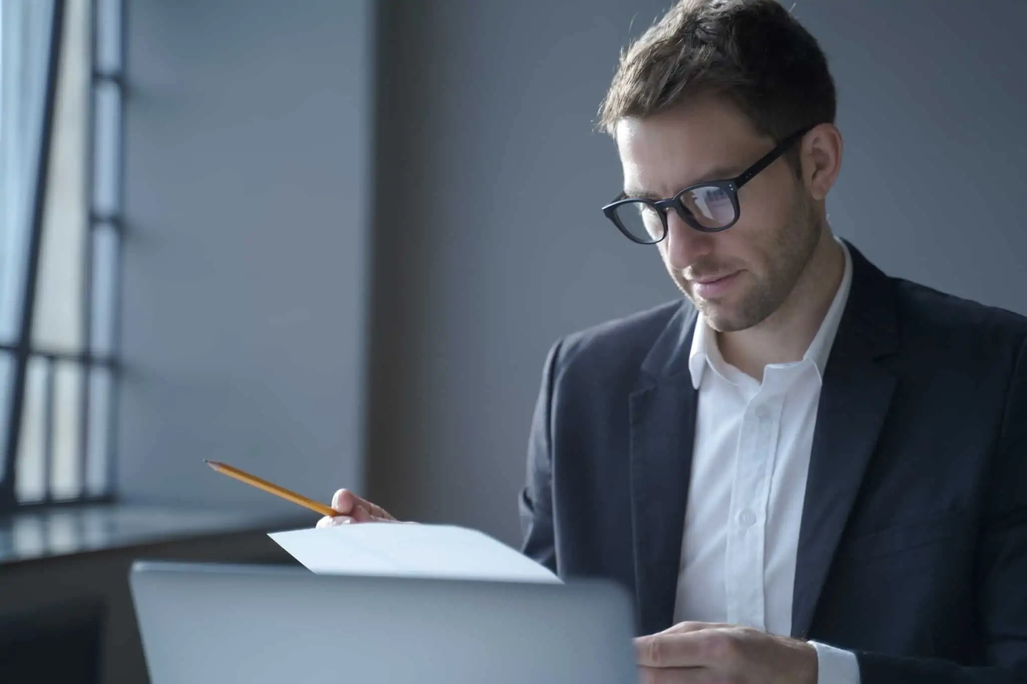 Certidão permanente: Como pedir e consultar homem jovem, com uma concentrado, analisa a certidão permanente predial