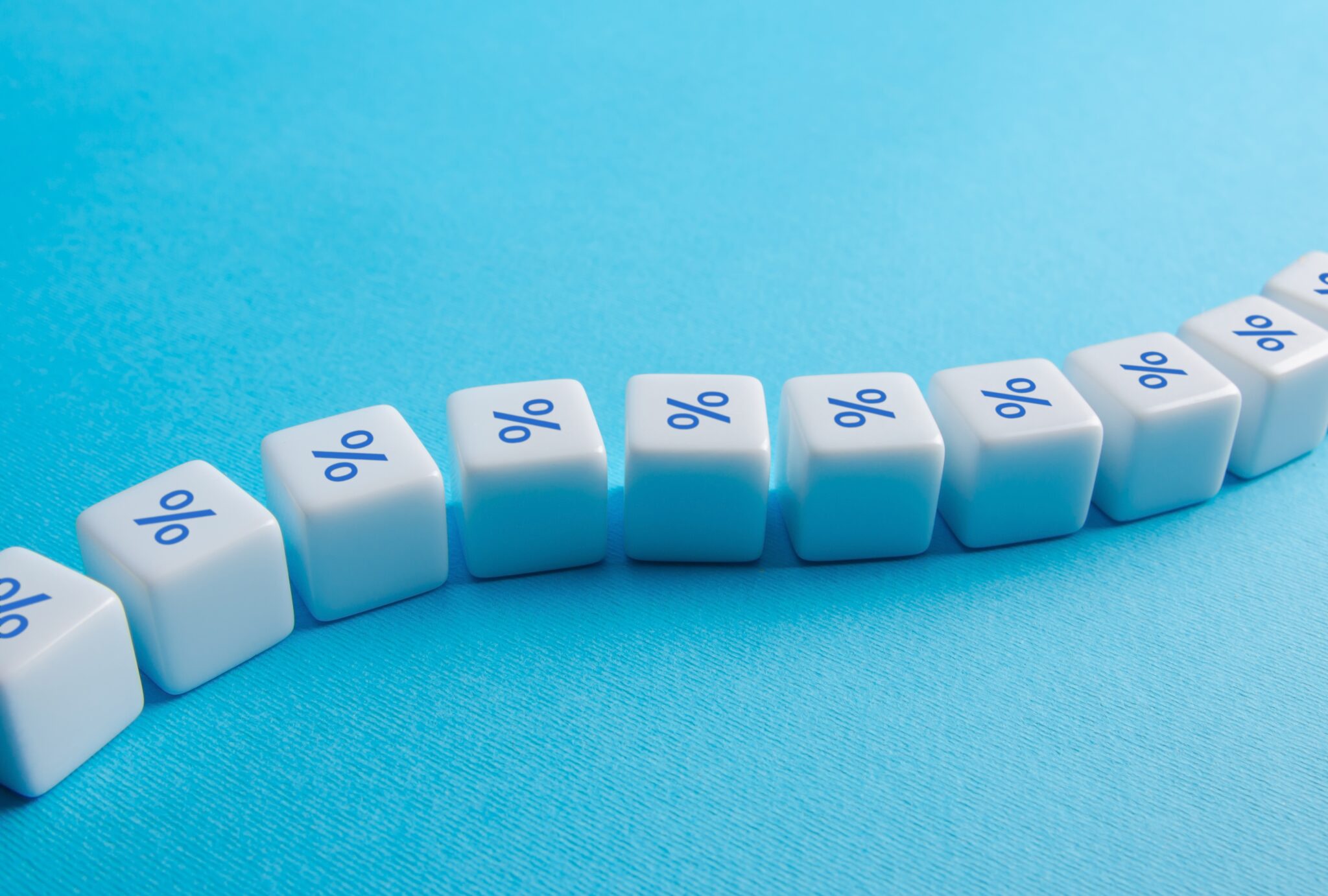 BCE volta a subir juros e avisa que aumentos vão continuar Dados com o símbolo da percentagem alinhados como uma corrente