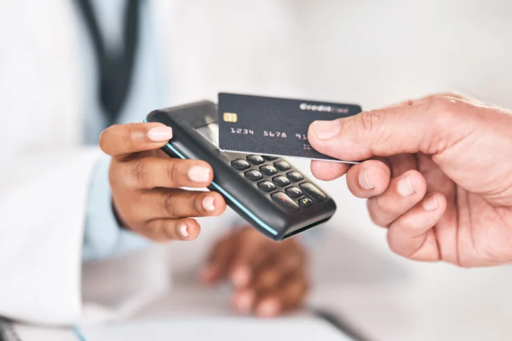 Homem paga com cartão de crédito num terminal de multibanco